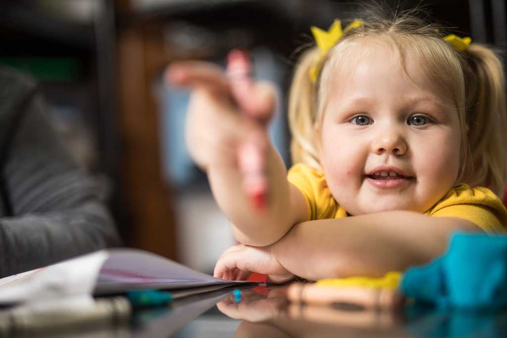 Little girl holding a crayon